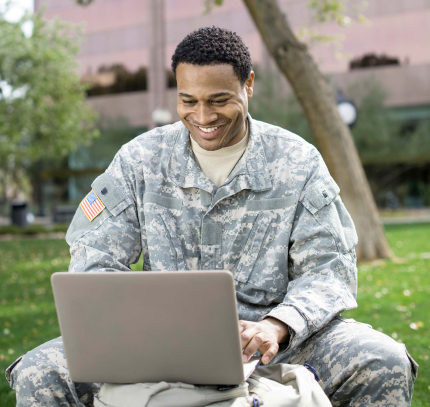 military personnel on his laptop