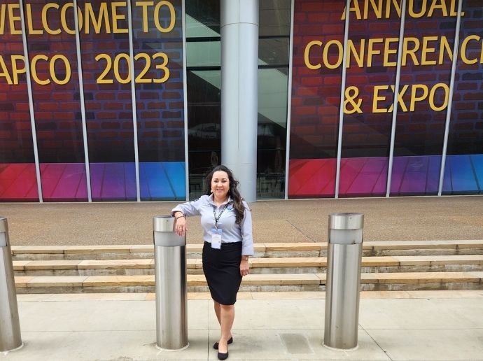 Ana Corcoran posing outside of a conferrence