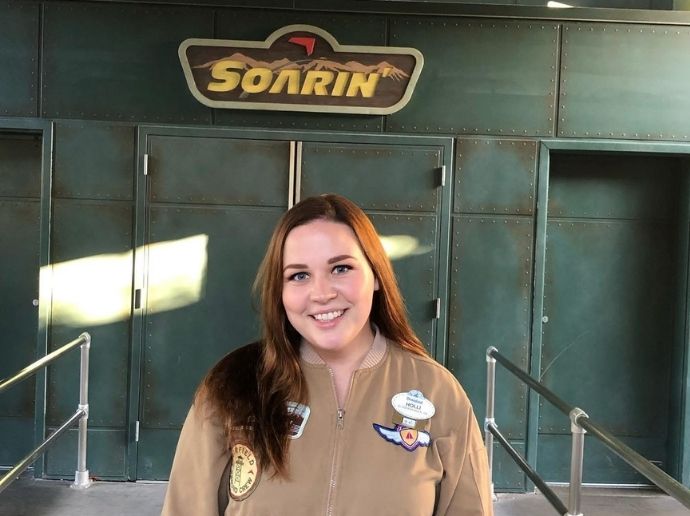 Holli smiling in front of a Disneyland attraction