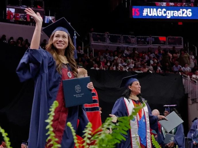 Jessa walking the spring 2026 UAGC commencement stage