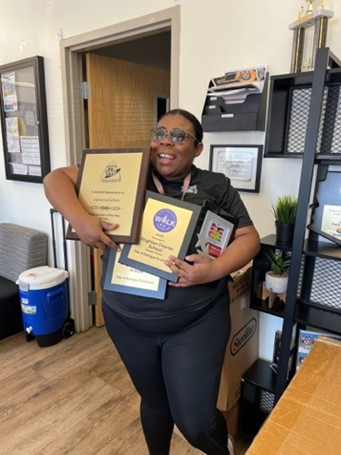 UAGC student Jyevonne Saffold holding awards