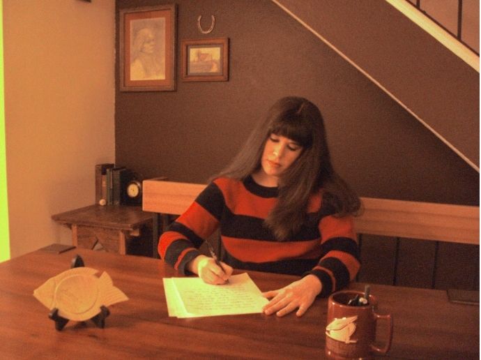 Kimberly Luke writing at home