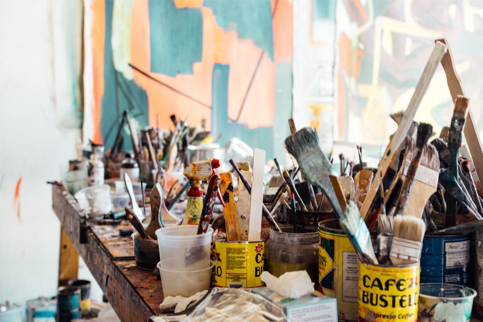 paint brushes in paint cans