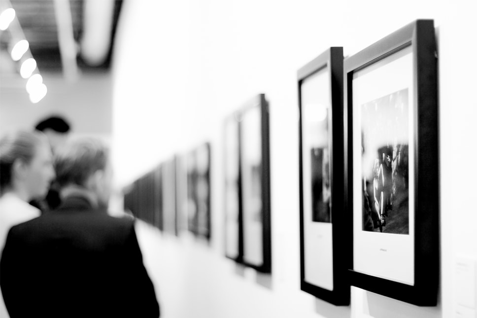 people viewing art in an art gallery