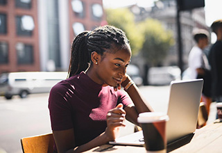 woman working outdoors on a laptop