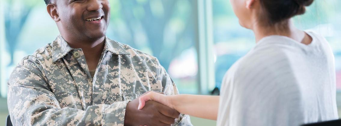 military person shaking hands with someone
