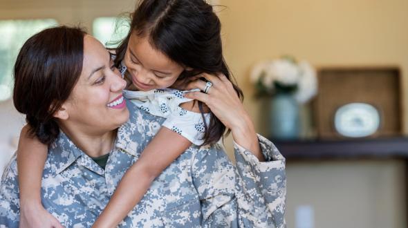 military woman with child on her back