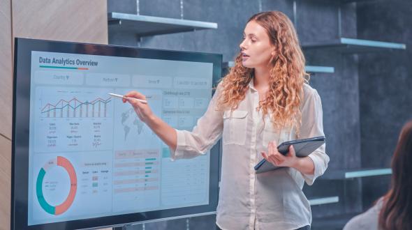 A woman leading an analytics presentation (Getty image)