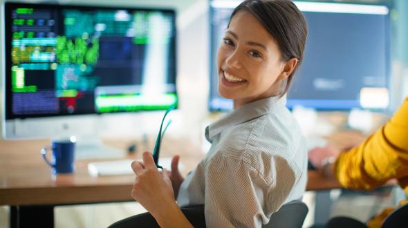 woman smiling at computer