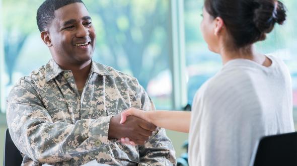 military person shaking hands with someone