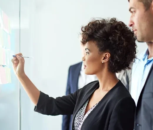 lady writing on glass board