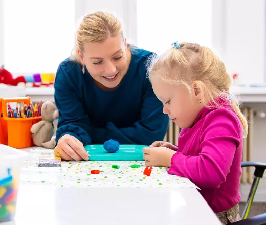 Teacher working with young child