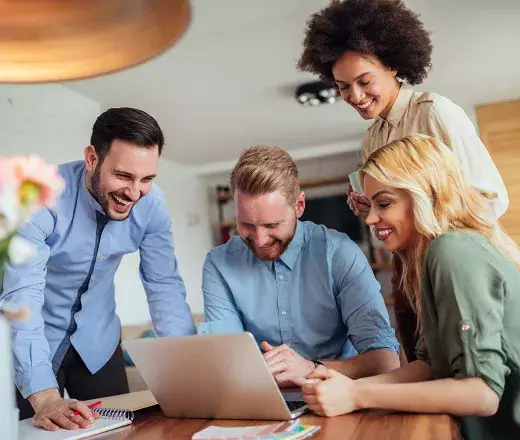 People working and looking over laptop