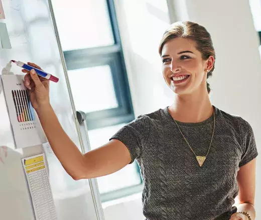 Lady writing on whiteboard