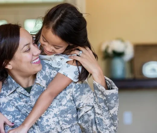 military woman with child on her back