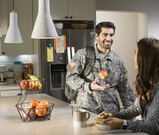 smiling military student in kitchen