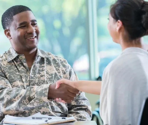 military person shaking hands with someone