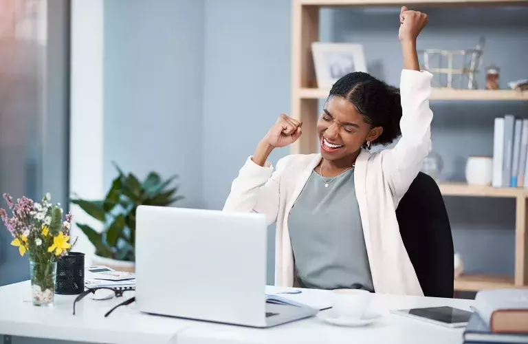 lady hooray gesture in front of laptop