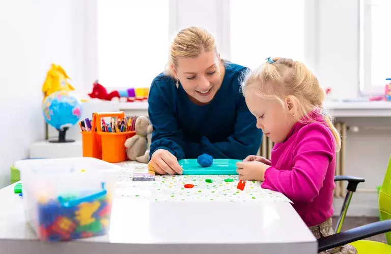 teacher working with young child