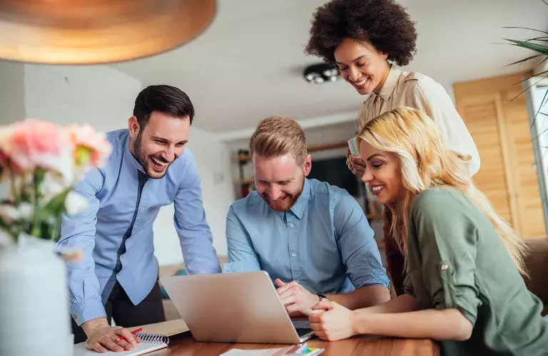 People working and looking over laptop