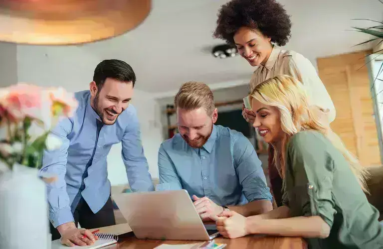 People working and looking over laptop