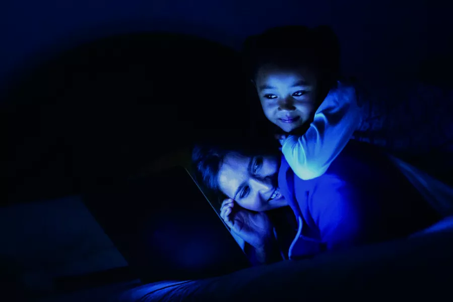 mother and daughter playing in the dark