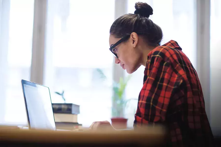 Woman writing the benefits of a liberal arts degree