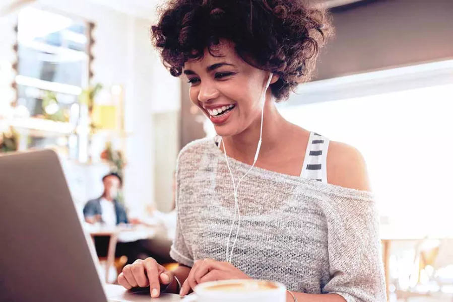 woman smiling while at laptop