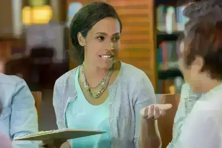 Lady holding tablet in library
