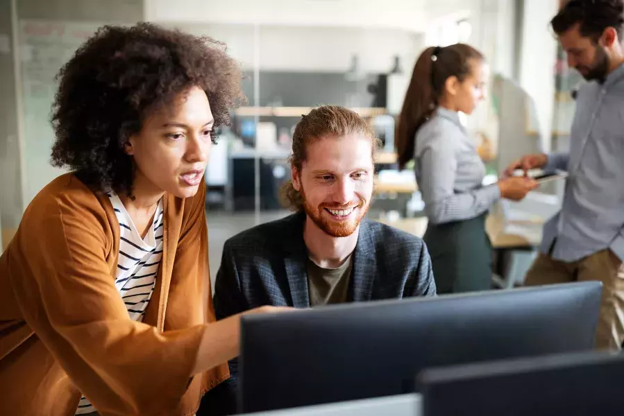 lady and guy discussing over computer