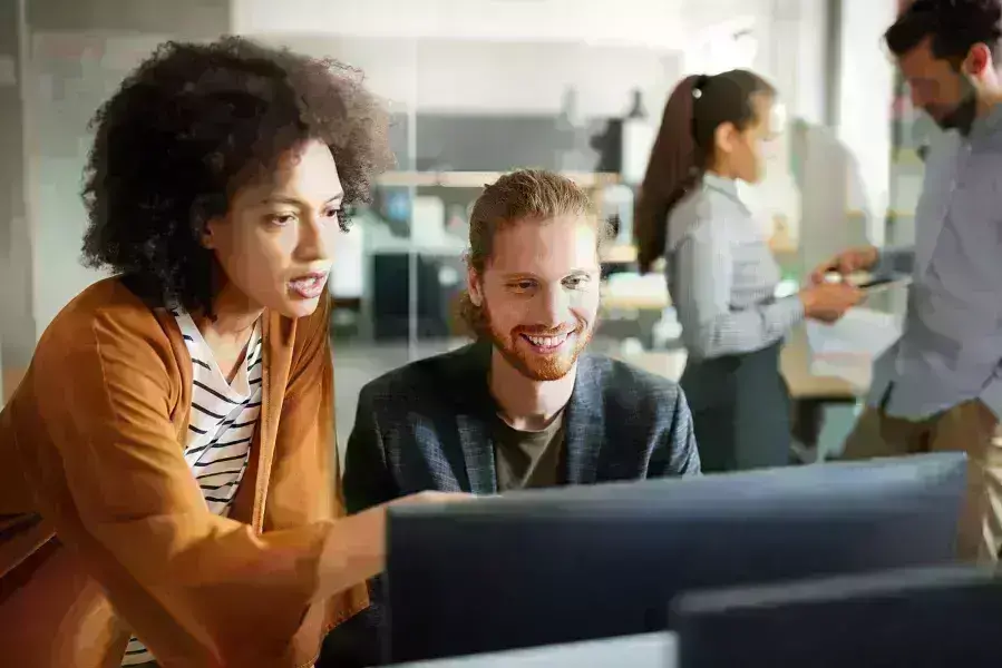 lady and guy discussing over computer