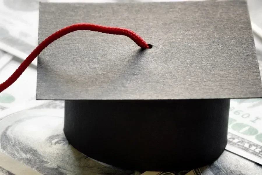 graduation cap on money