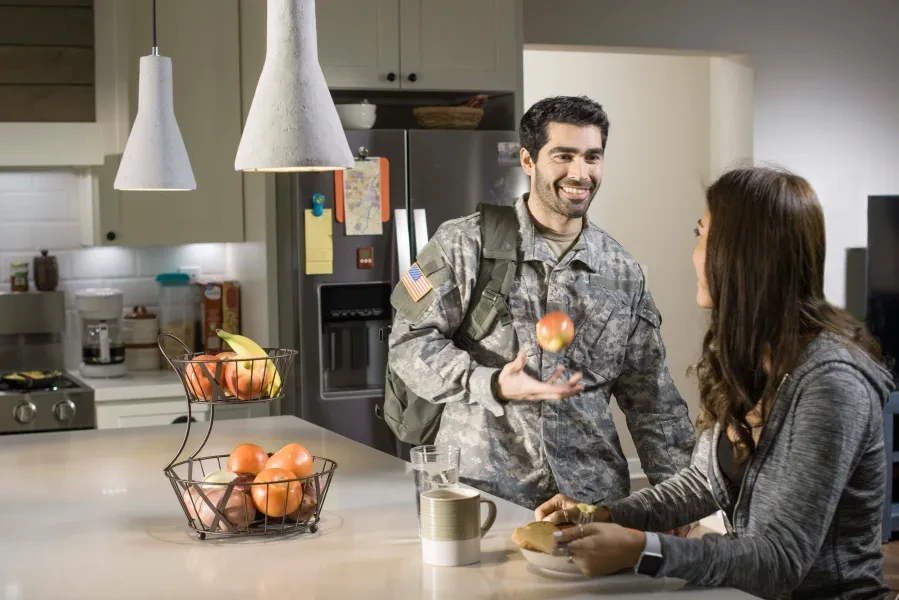 smiling military student in kitchen