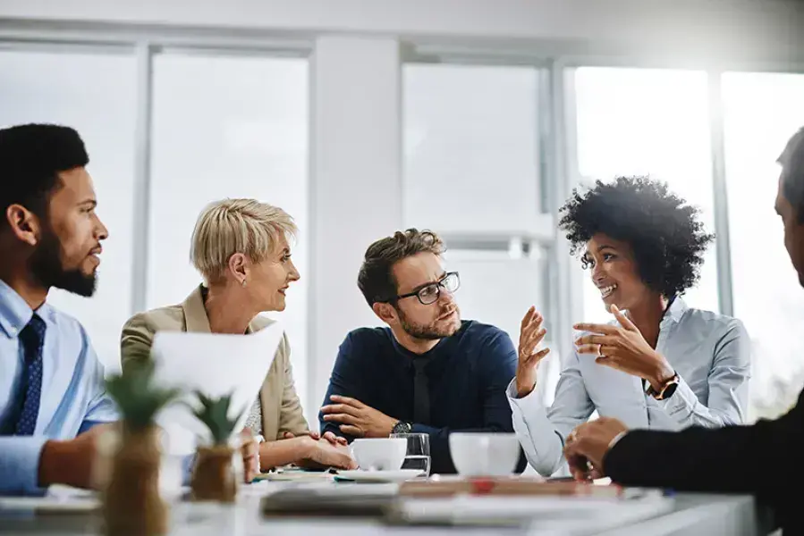 people having a conversation in meeting