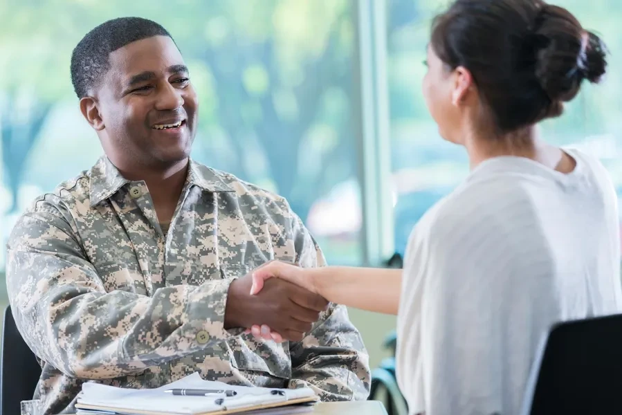 military person shaking hands with someone