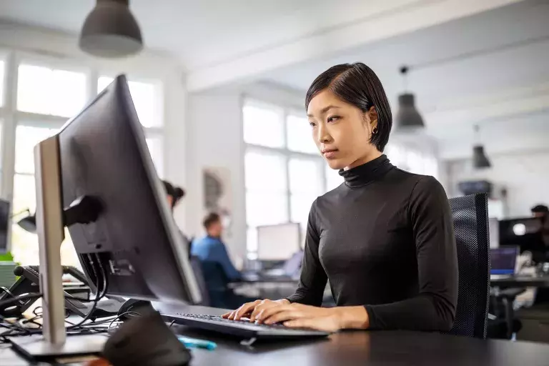 Lady typing in front of computer