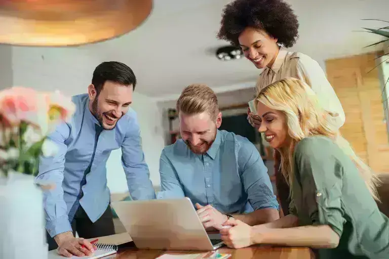 Professionals discussing in front of a laptop