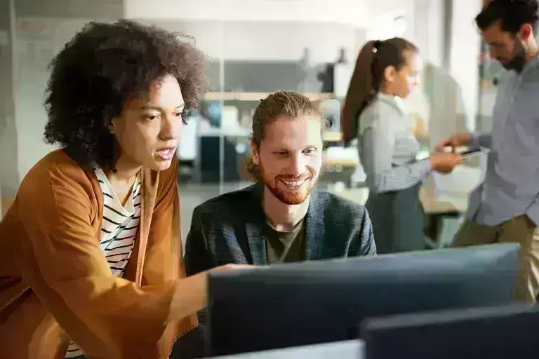 lady and guy discussing over computer