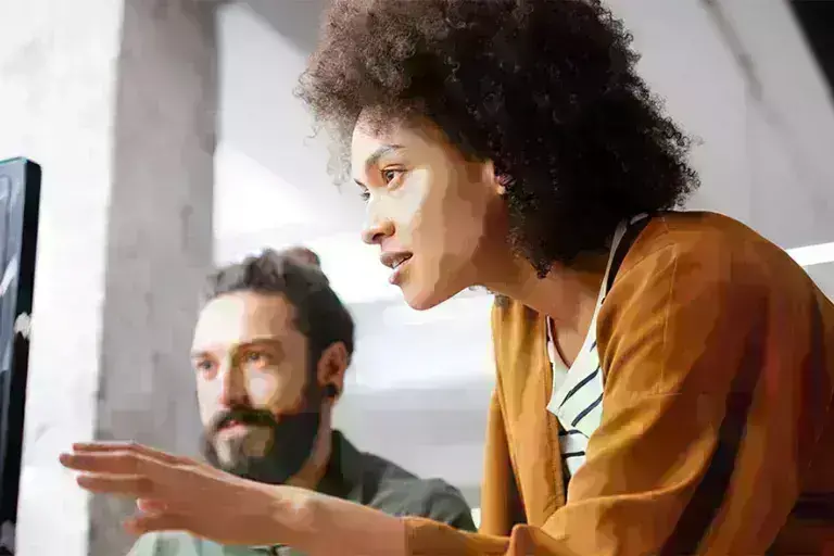 Lady and guy discussing over computer