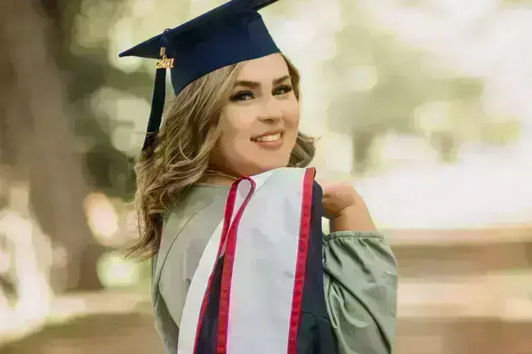 UAGC graduate woman in robes