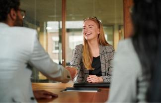 A person is shaking hands with a person in an office. Photo from Getty Images